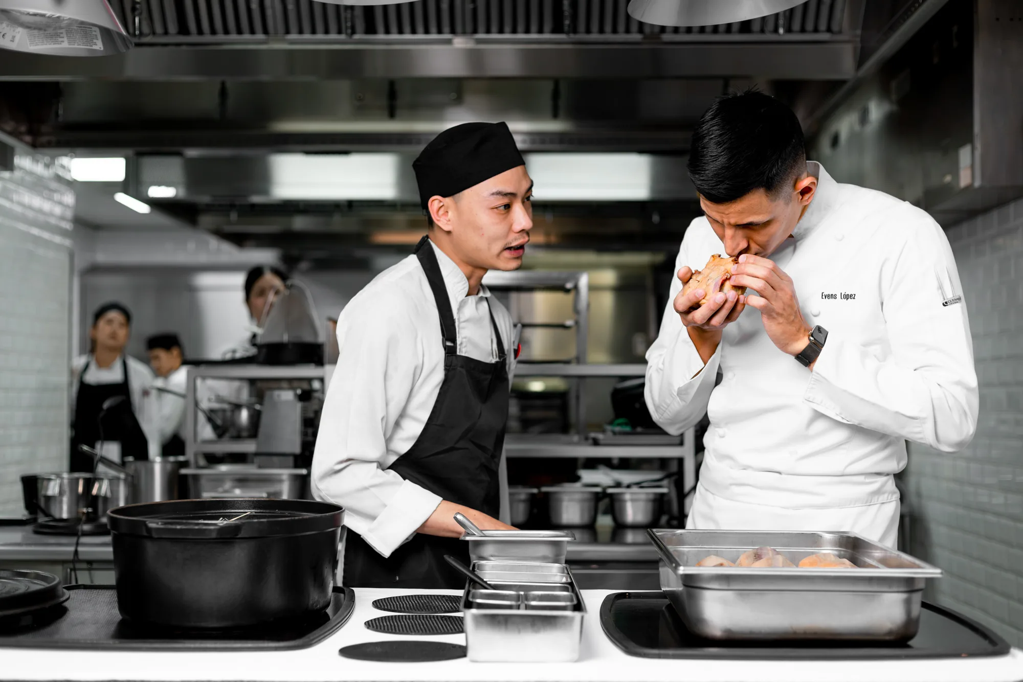 BLUE chefs inspecting an ingredient before service.