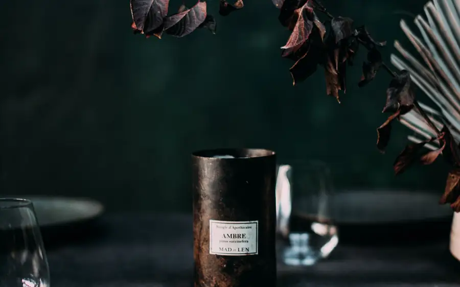 A copper candle on a linen table