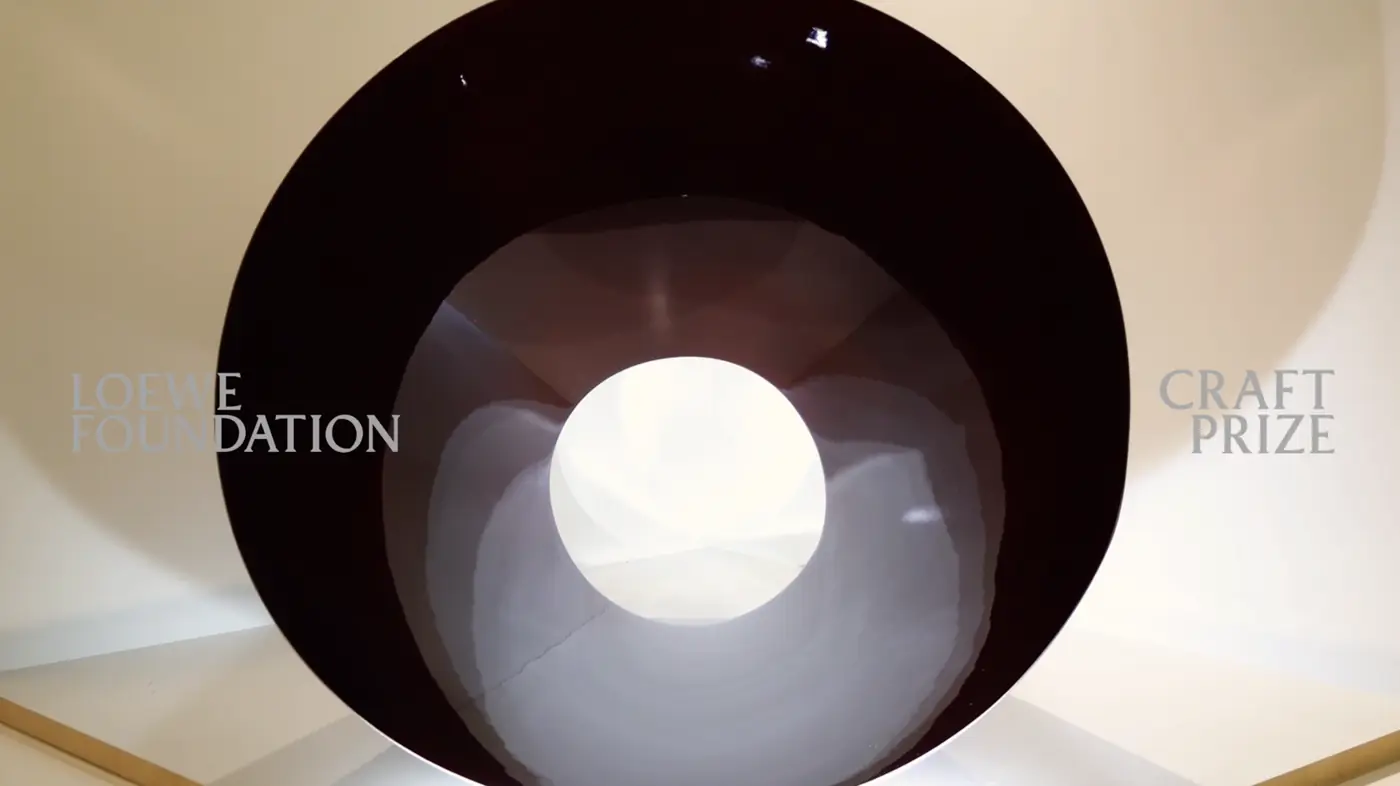 Large black vessel facing the camera in Laying Vessel by Jobe Burns
