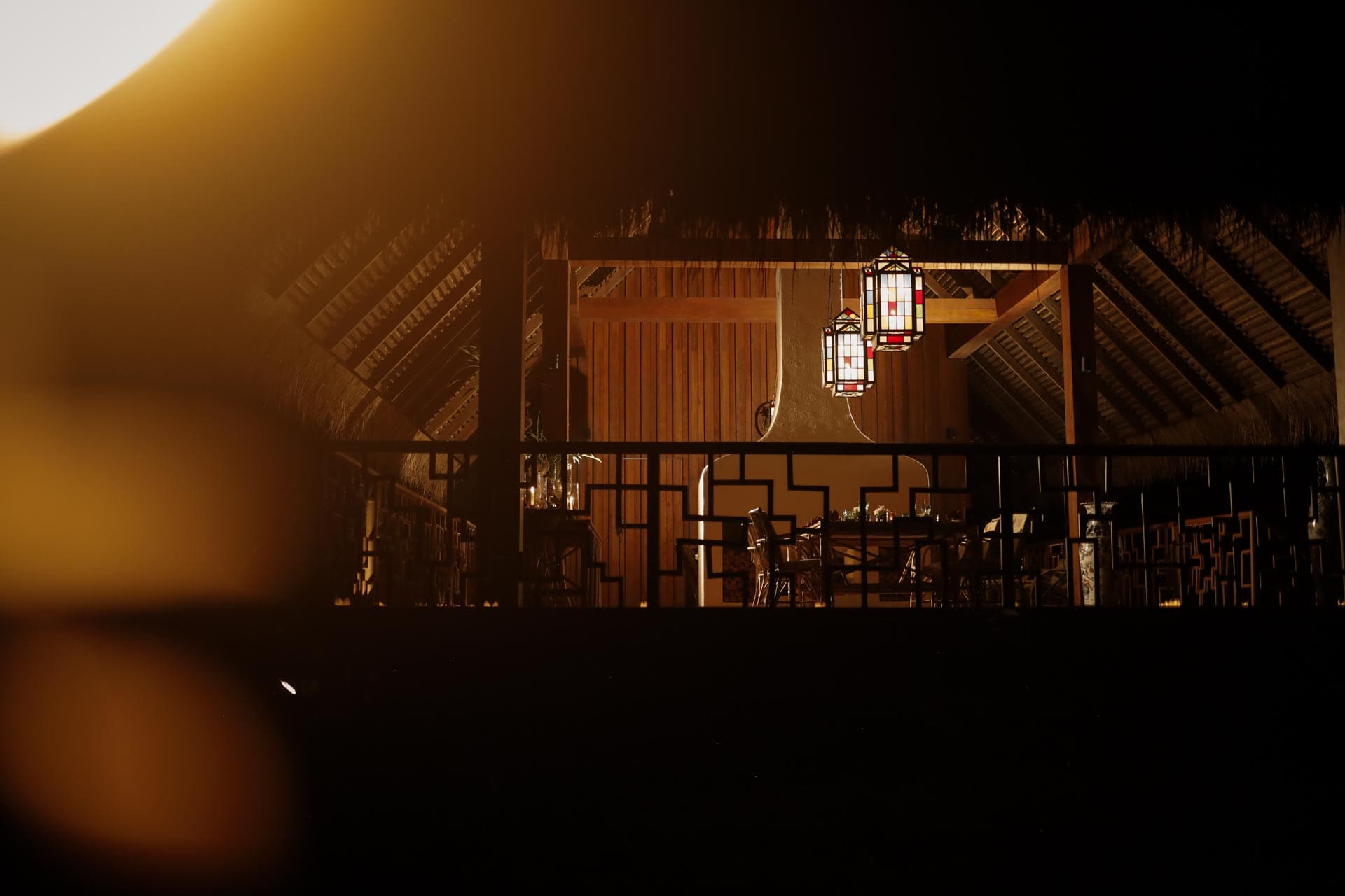 Lanterns illuminate a timber pavilion at Tatvani, photographed by VOLANTT.