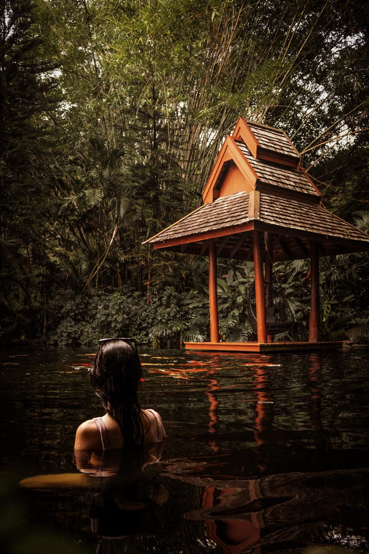 Portrait view of Tatvani’s pool, Thai pavilion and surrounding bamboo.