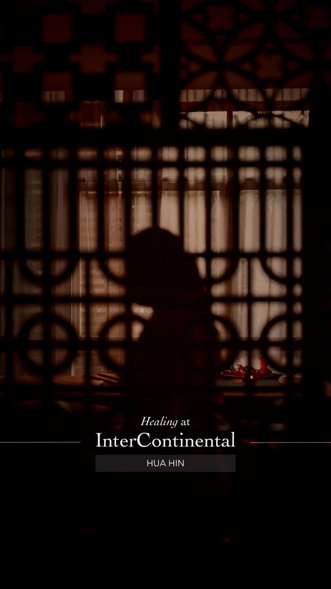 Cover of the InterContinental Hua Hin spa film, a silhouette behind a carved timber screen
