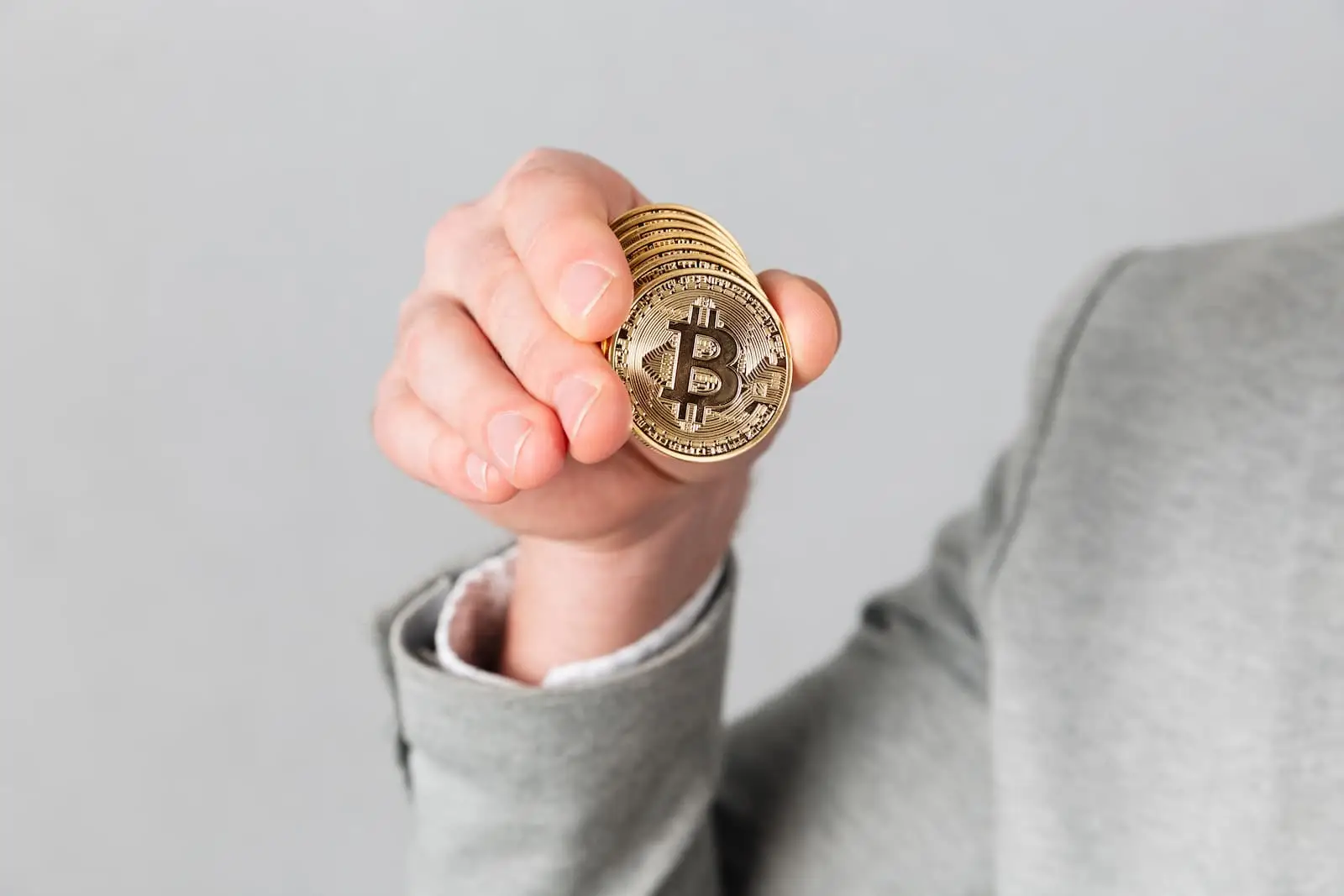 A man shows a bitcoin coin