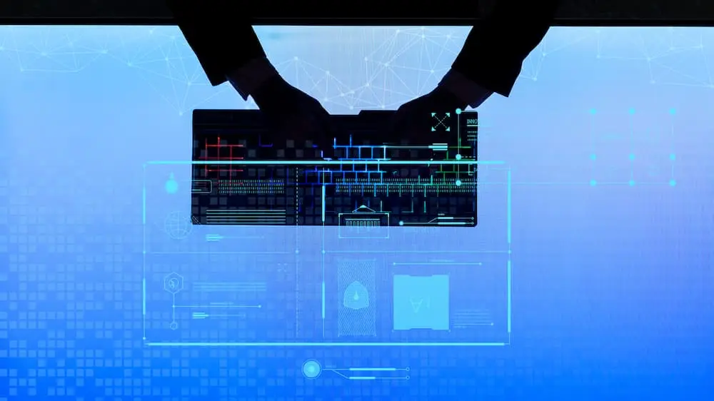 an image of a silhouette of hands holding a keyboard on a blue background