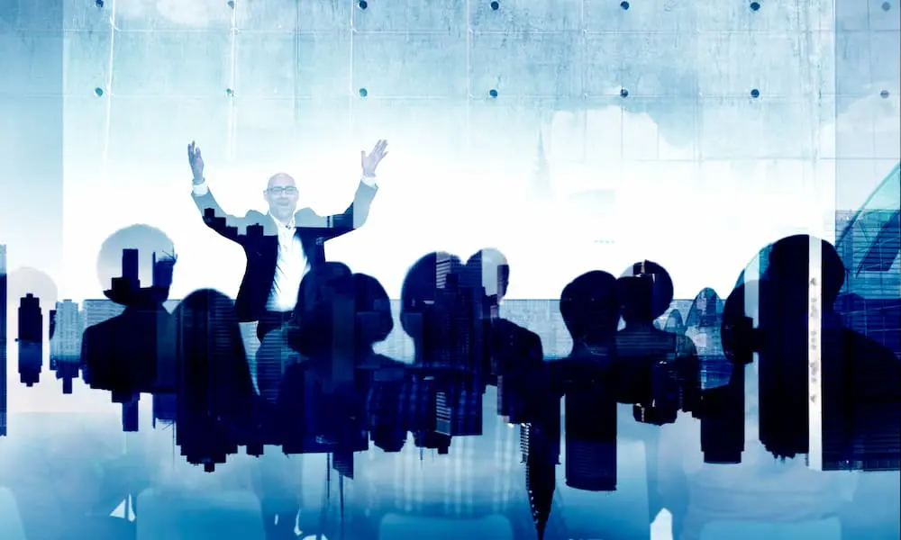 an image of a conference and a man speaking