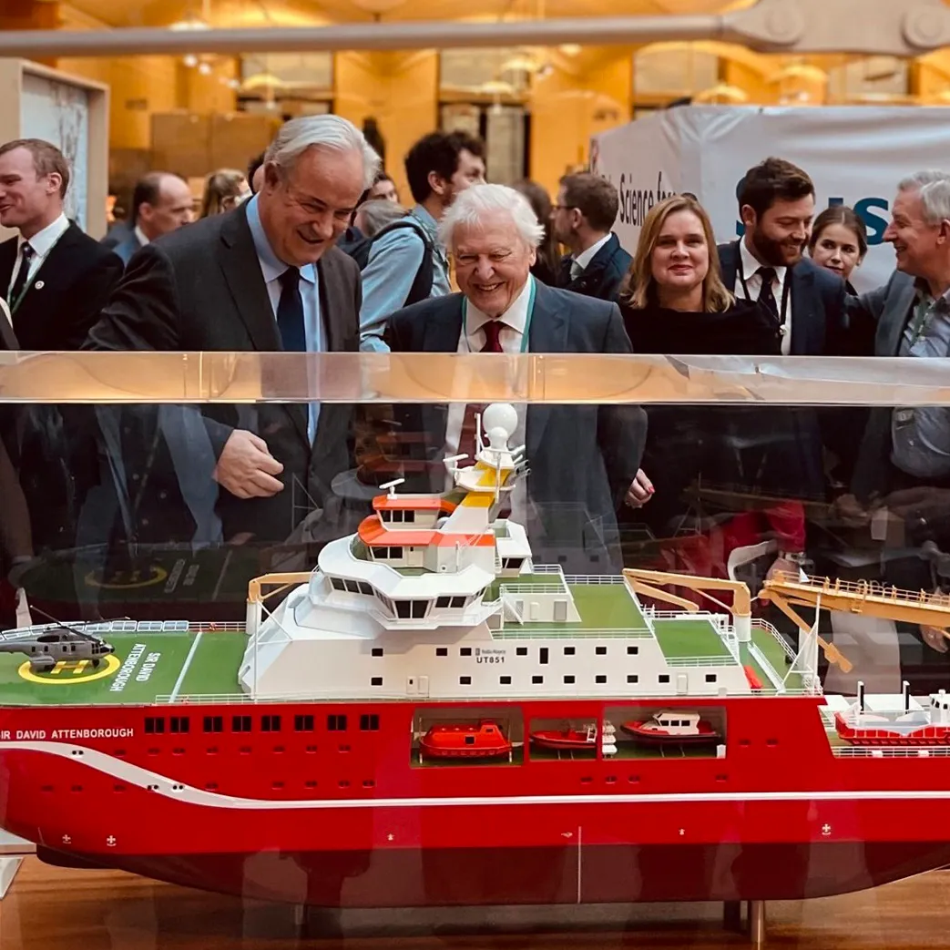 Sir David Attenborough and James Gray MP looking at a model of the RRS Sir David Attenborough at the First Ice Exhibition, 2023