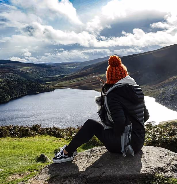 person looking out at a stunning lake