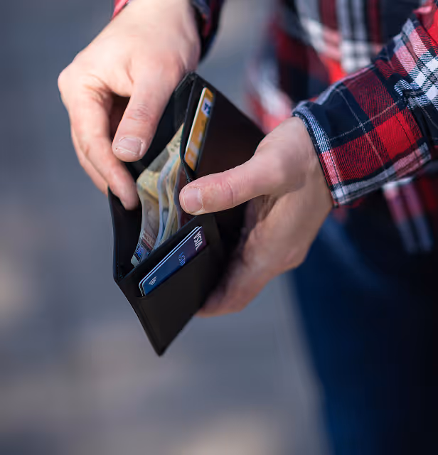 person looking through their wallet