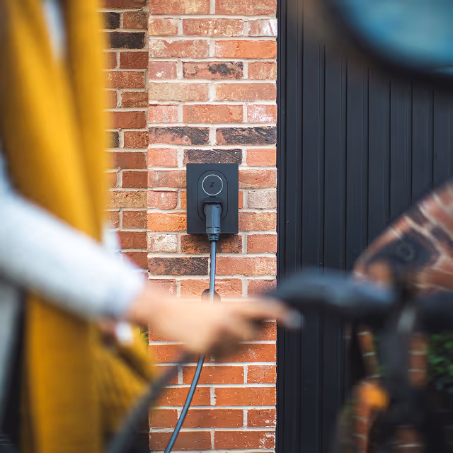person charging the car at home