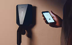 person checking their ev charger with their phone