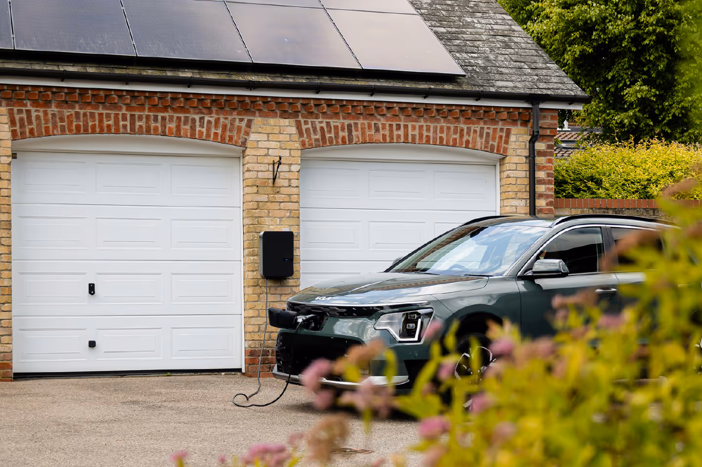 car plugged into a brick home