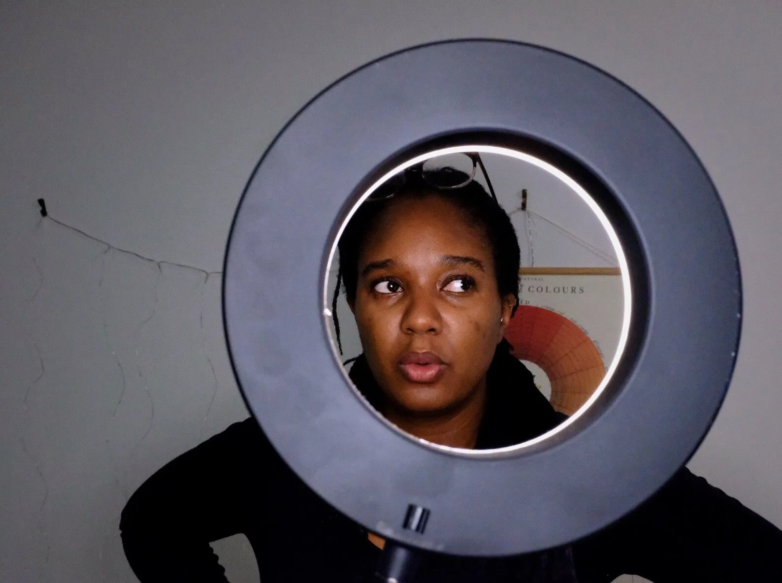 a person looking through a circular light