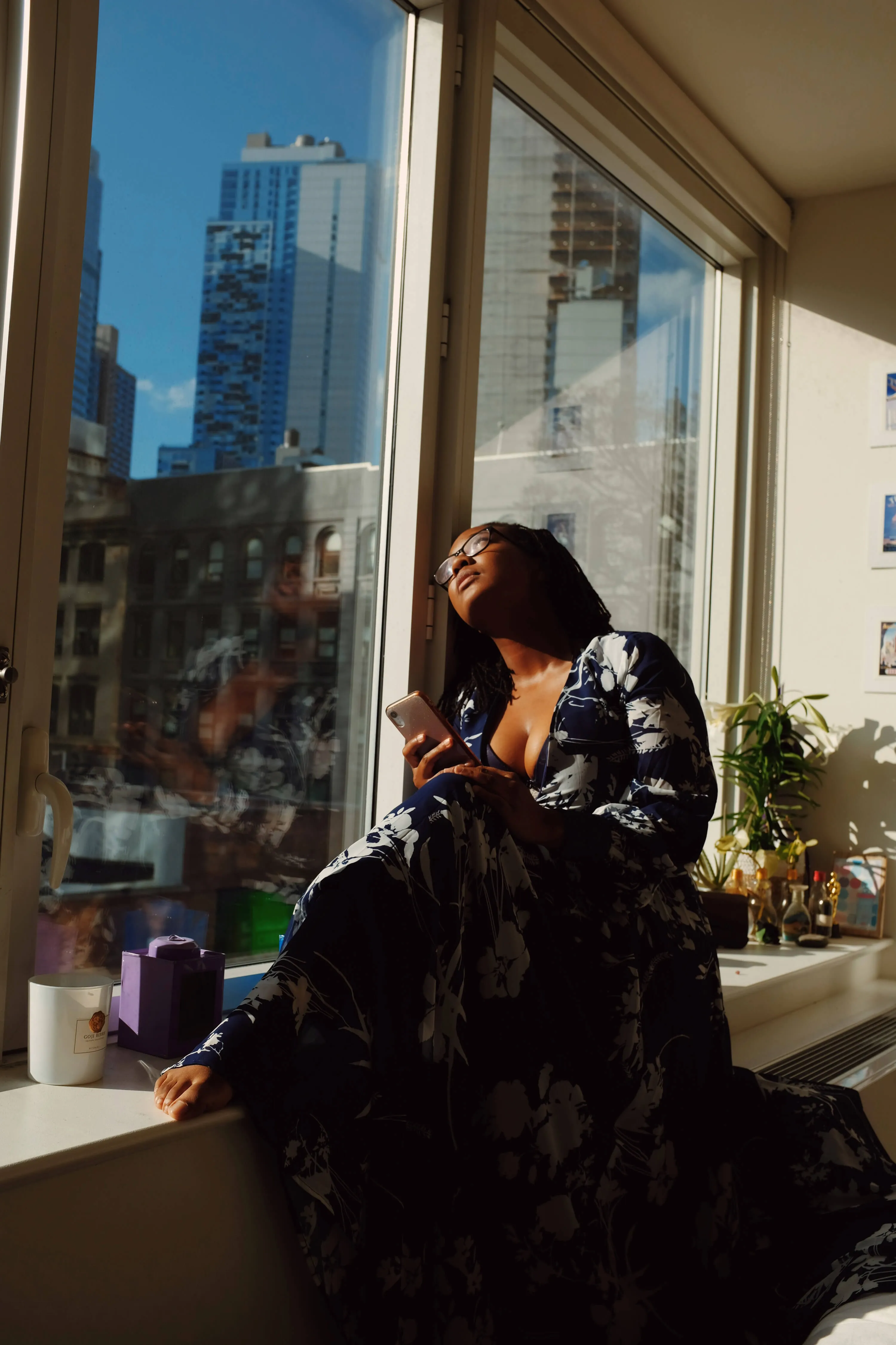 woman sitting in a windowsill in the sun