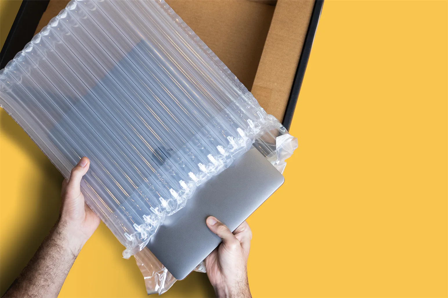 Laptop being put in protective shipping case