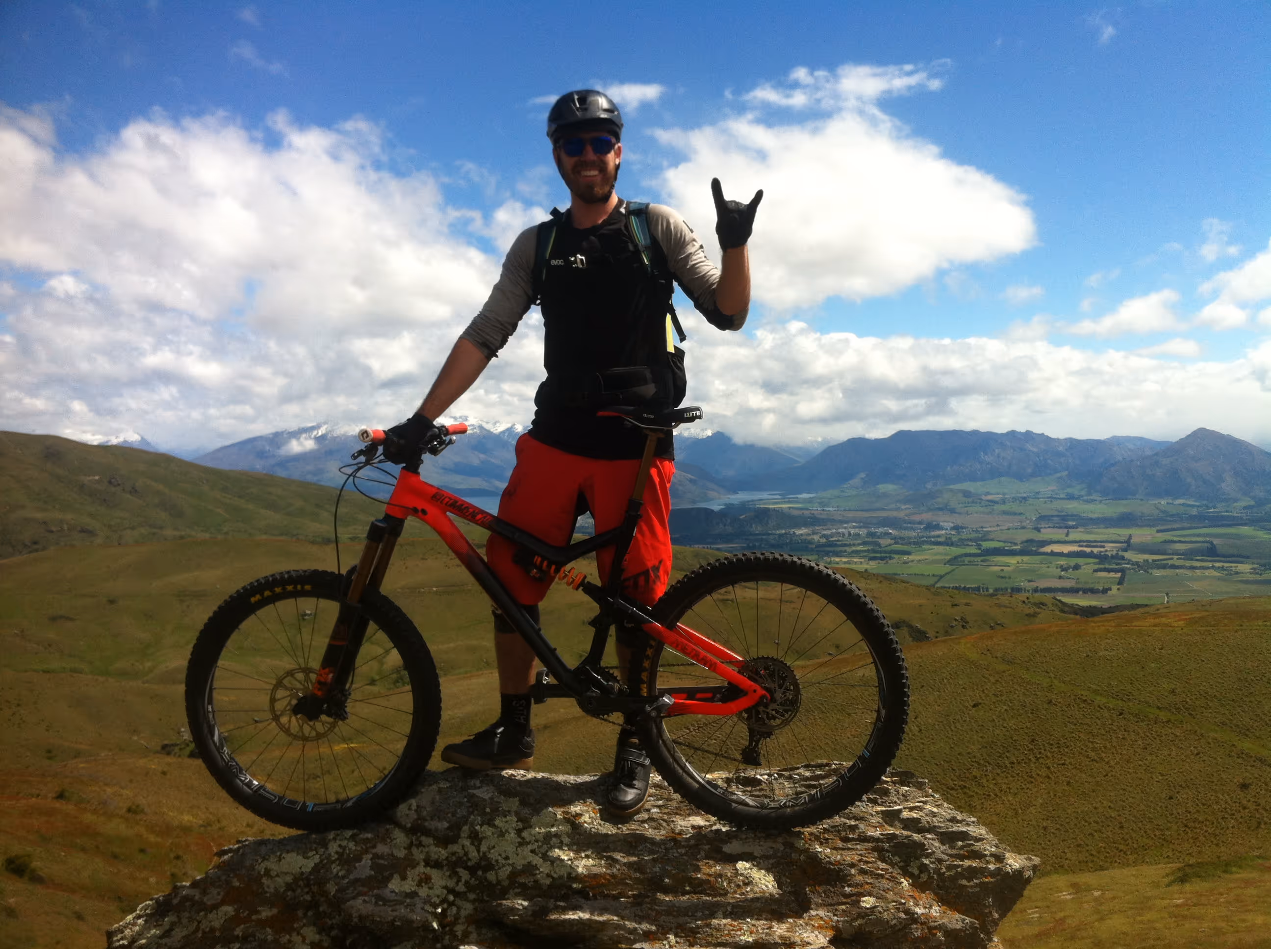 Triumphantly standing on top of a mountain peak