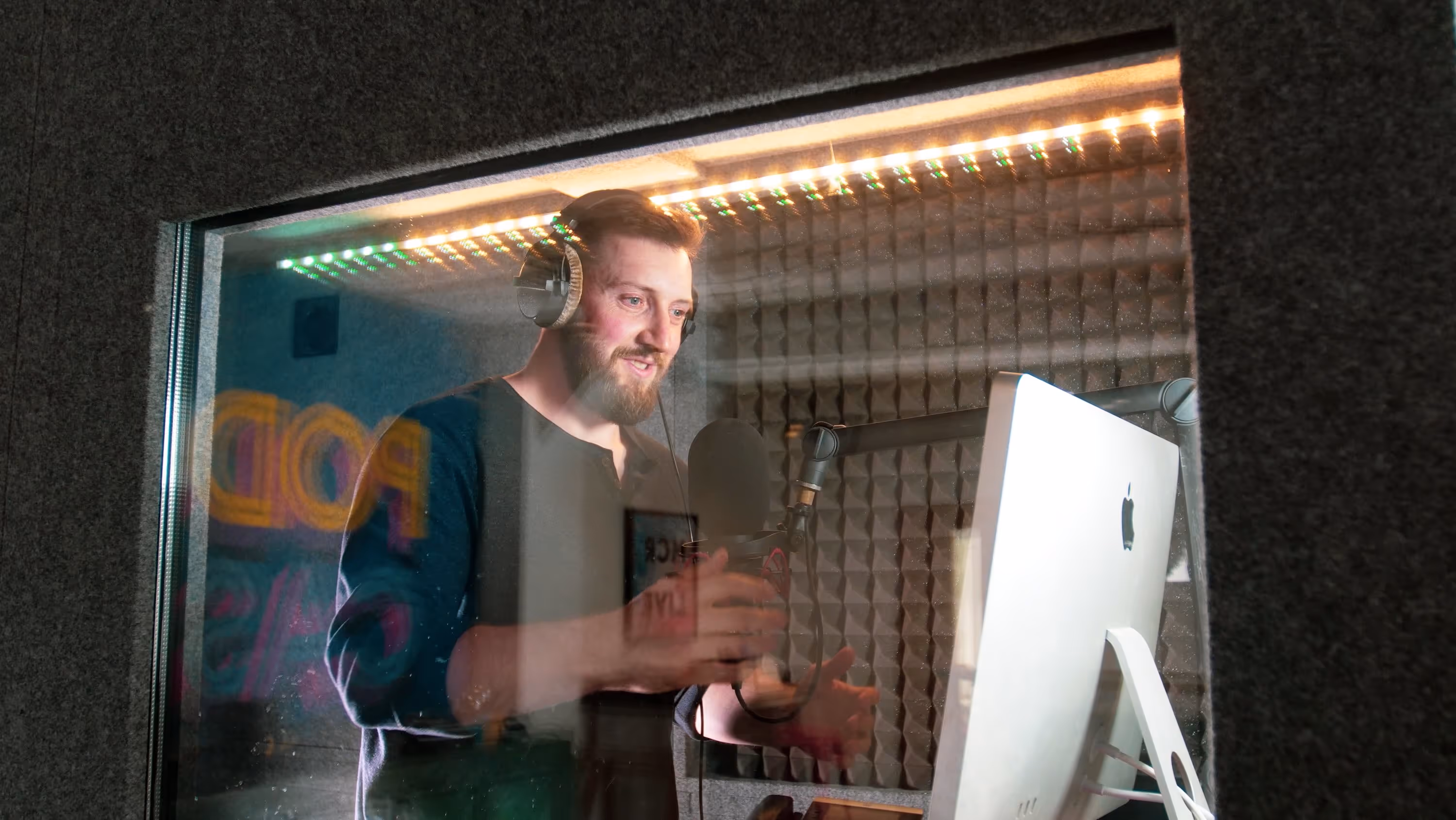 Cue Podcasts producer at sound booth.