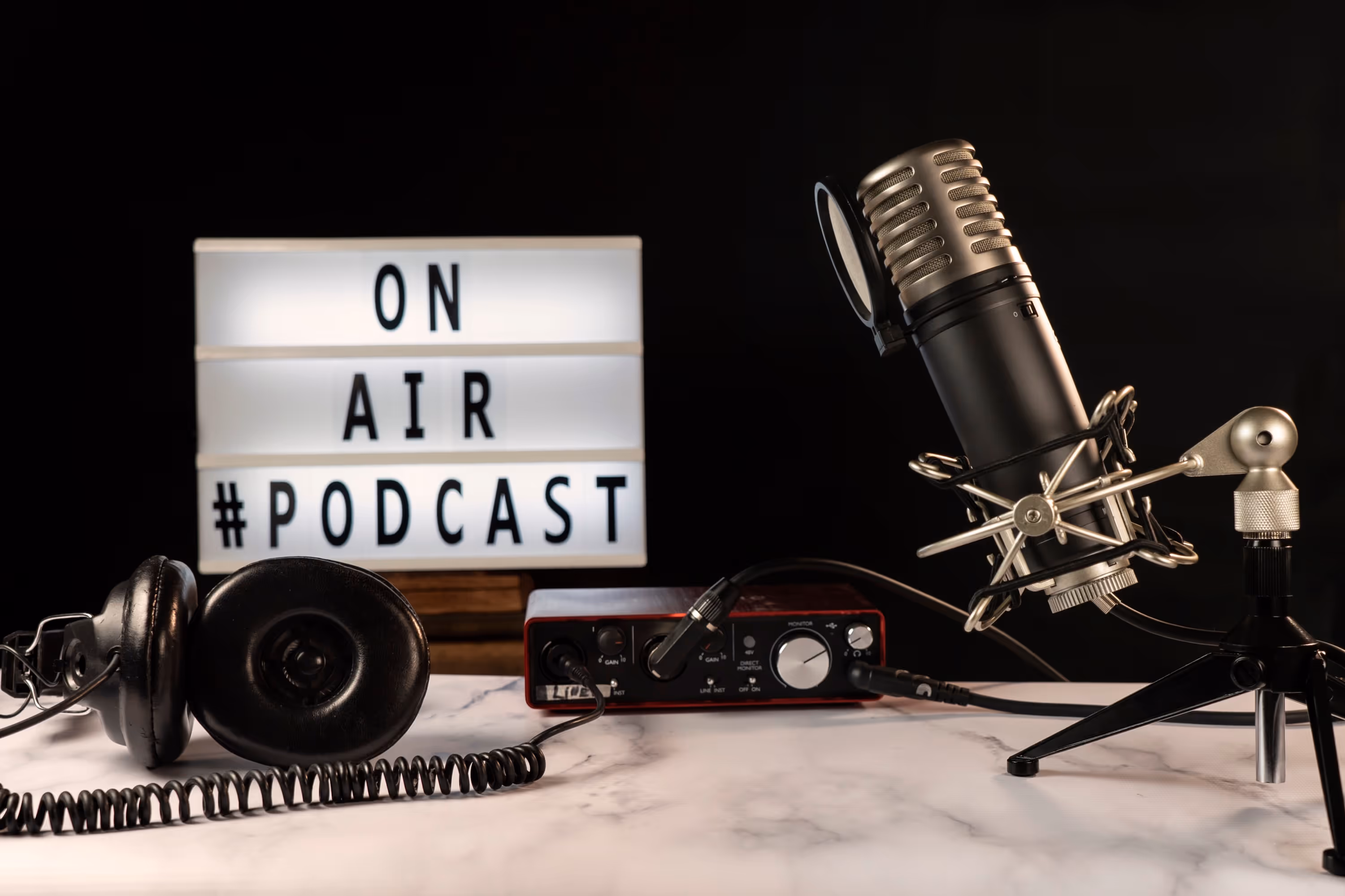 Table with microphone, "On Air" lightbox, and headphones
