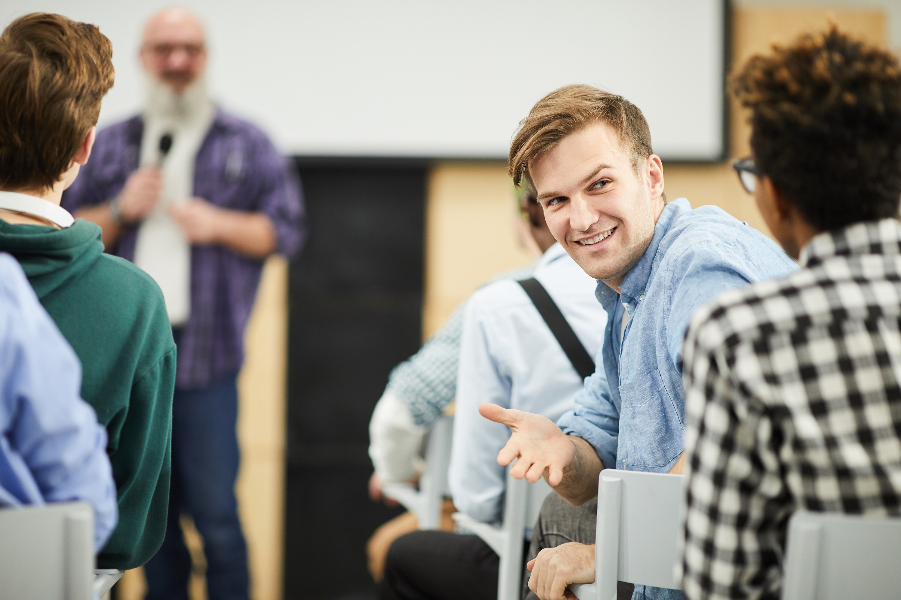 Person in audience talking to another person
