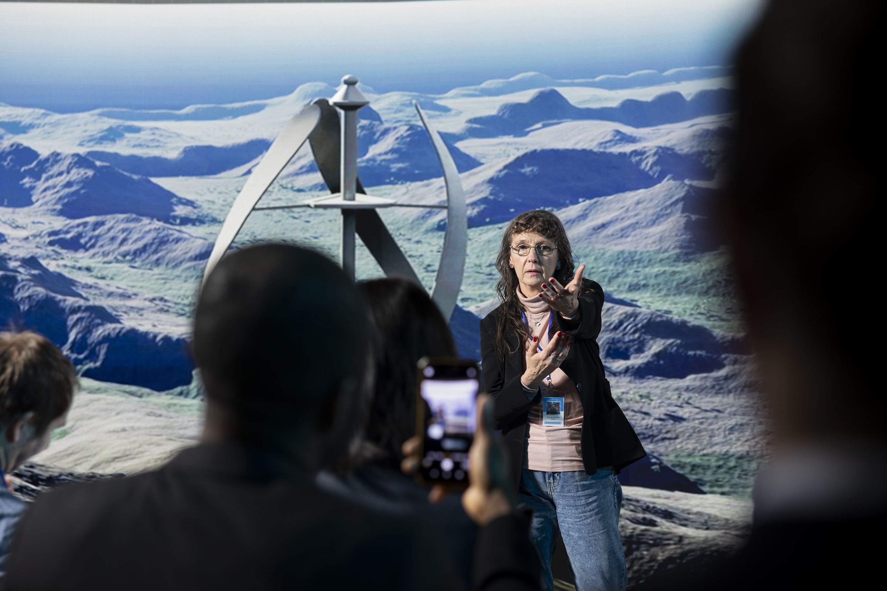 Woman speaking at event in front of audience
