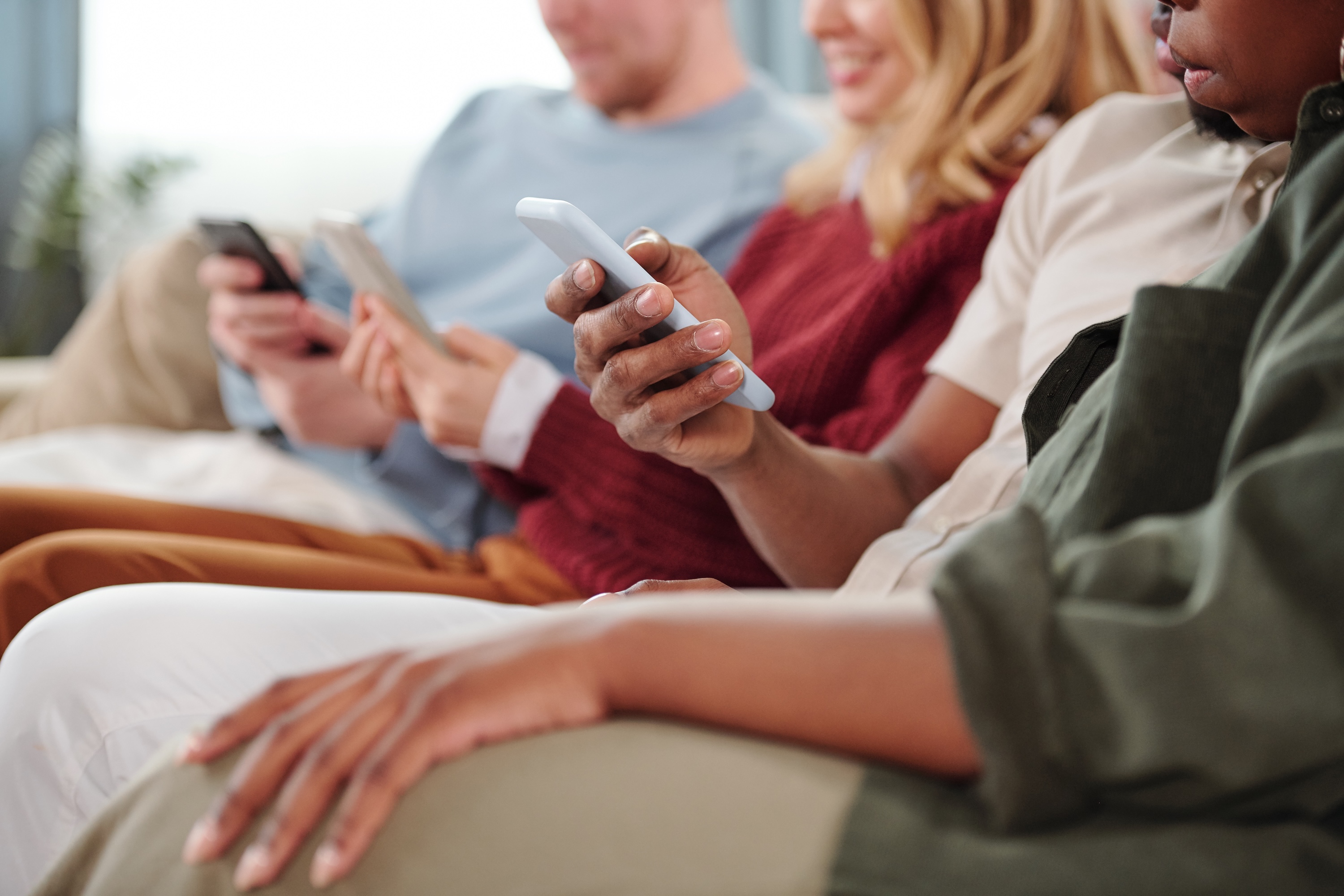 Group of people scrolling on mobile phones