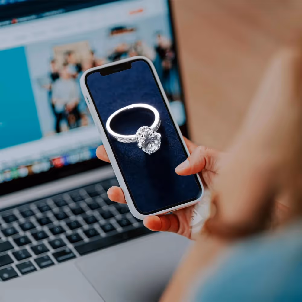 A smartphone displaying a diamond ring, symbolizing an improved jewelry shopping experience with WhizzBridge’s Shopify solutions.