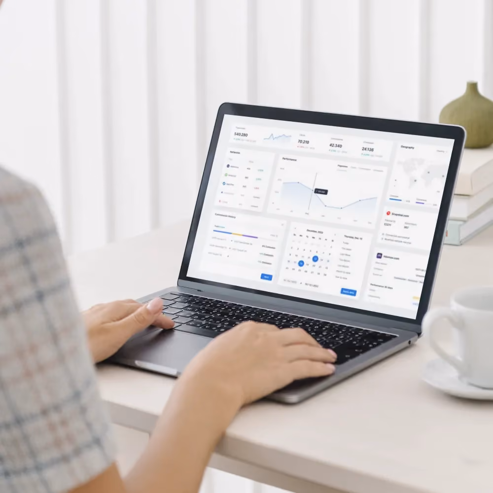 A woman interacts with a laptop featuring a dashboard, illustrating the new website which focus on language localization and user experience.