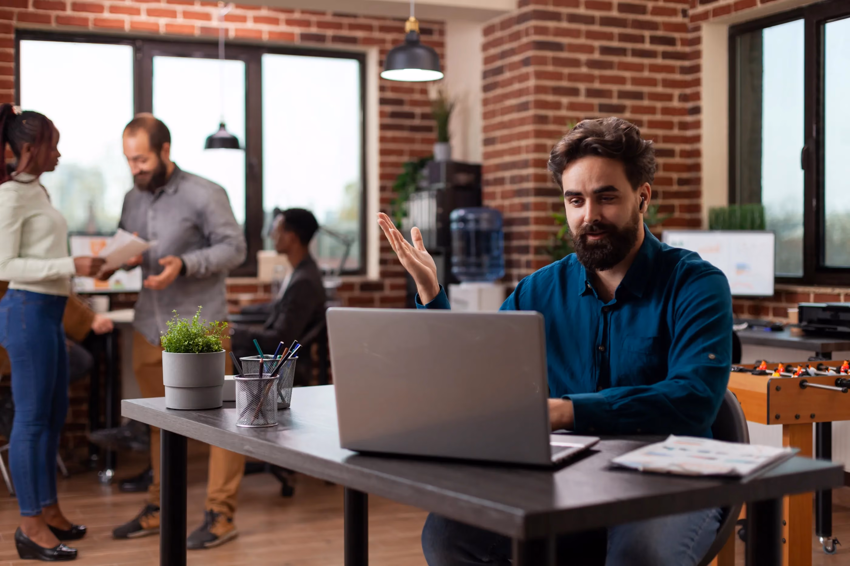 A man sits at a desk with a laptop, focused on streamlining operations using a custom Salesforce CRM.