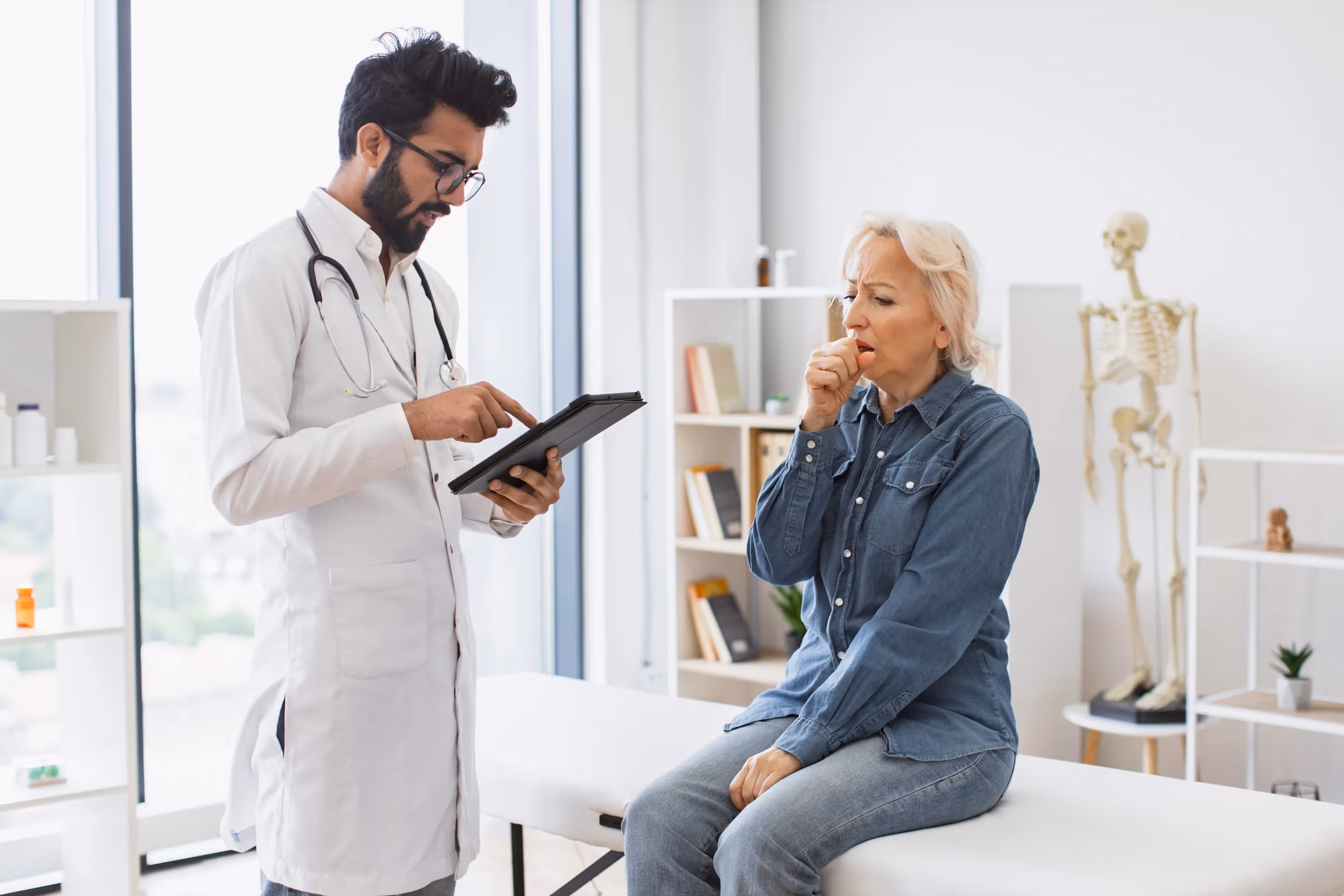 A doctor discusses hormone pellet therapy with a woman in a clinical setting, highlighting patient care.