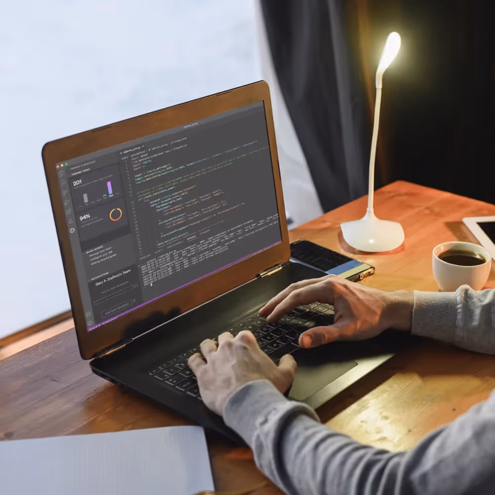 A man types on a laptop, utilizing AI tools for automated coding and quality assurance in a seamless workflow.