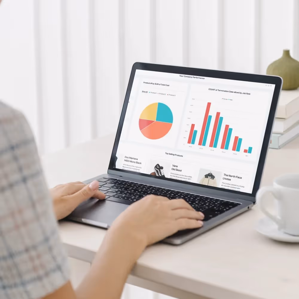 A woman works on a laptop displaying a chart, focusing on data analysis and optimization strategies for simulations.