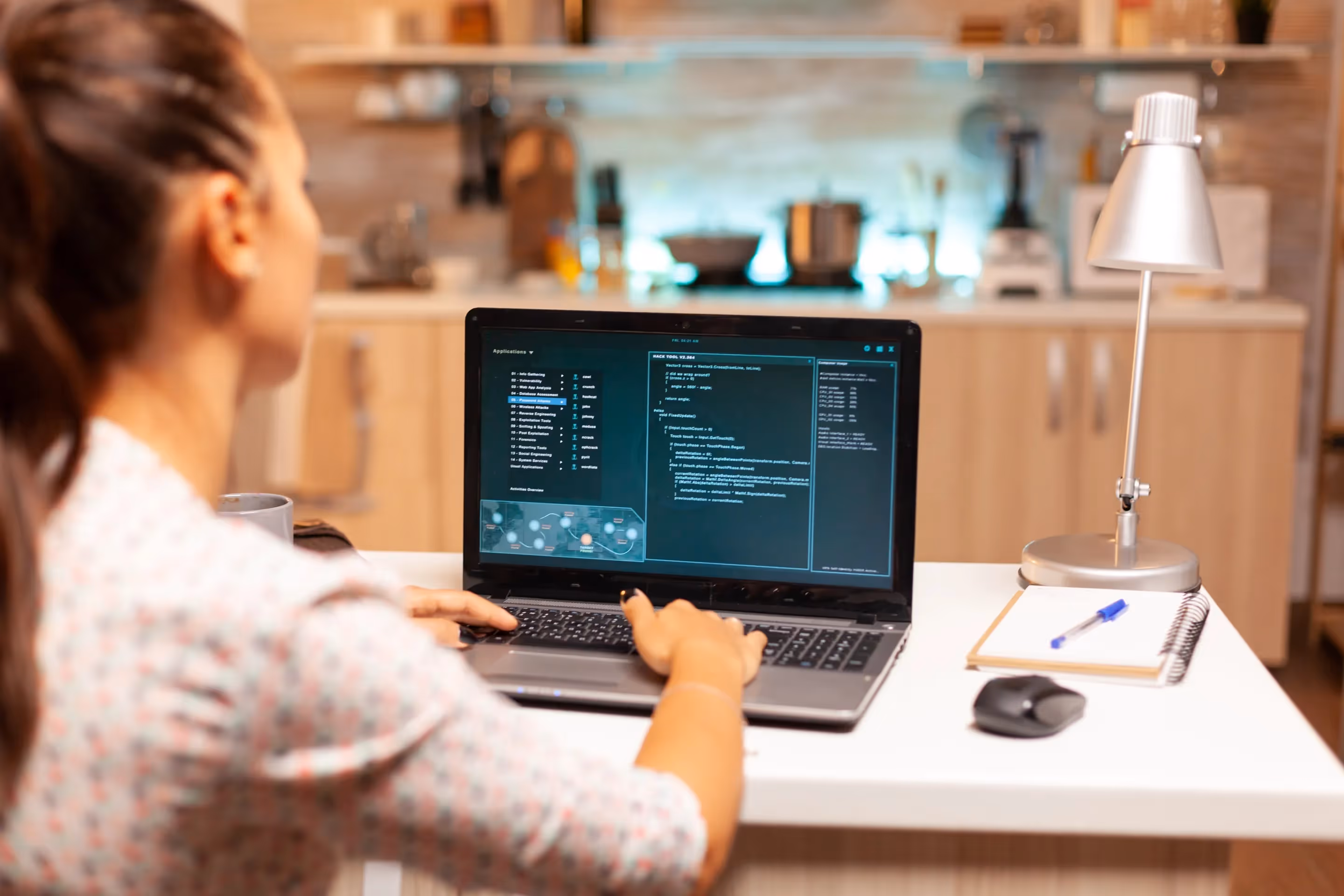 A woman sits in her kitchen, focused on her laptop, representing the blend of home and work life in the digital age.