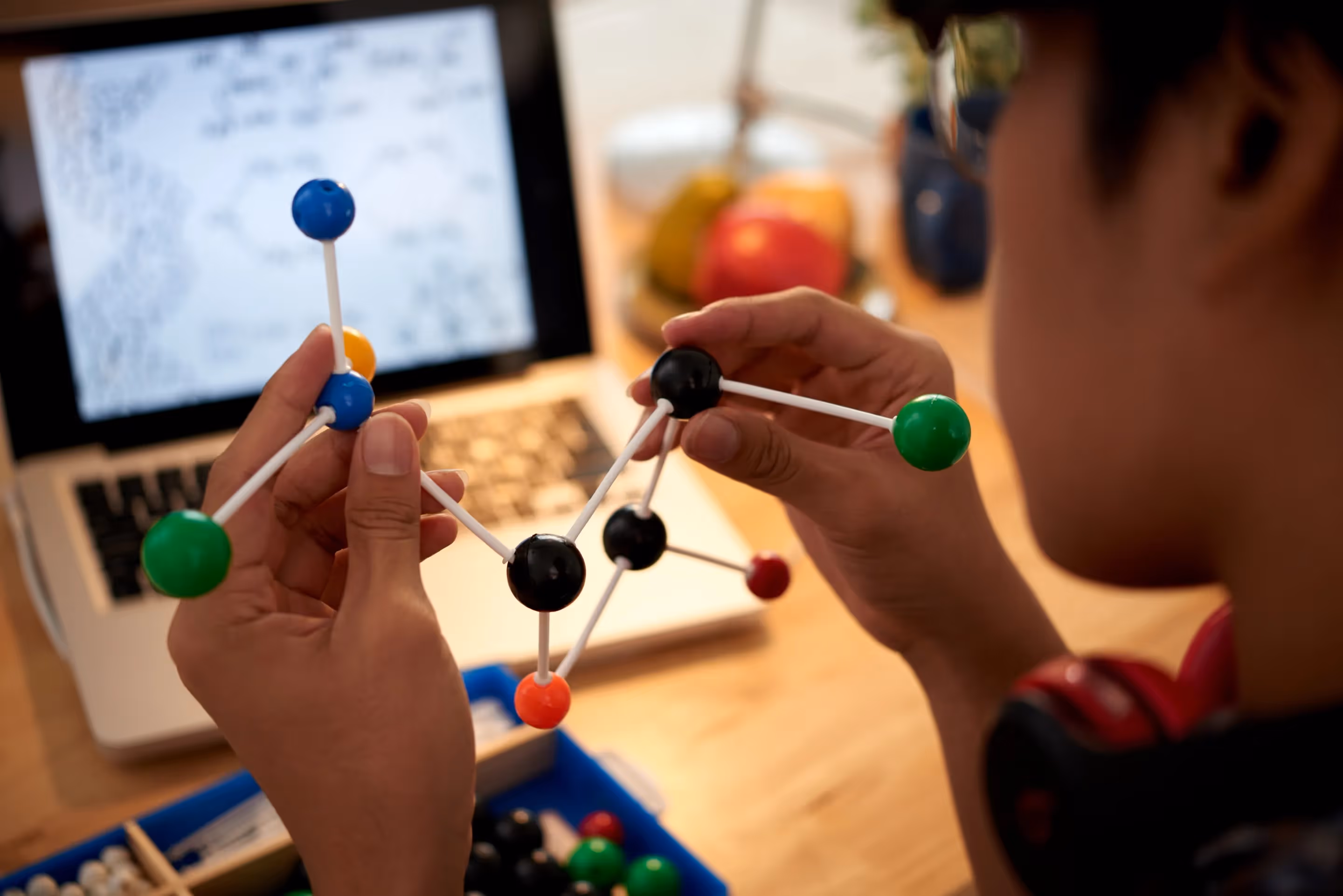 A person constructs a molecular model, showcasing innovative educational technology in action.