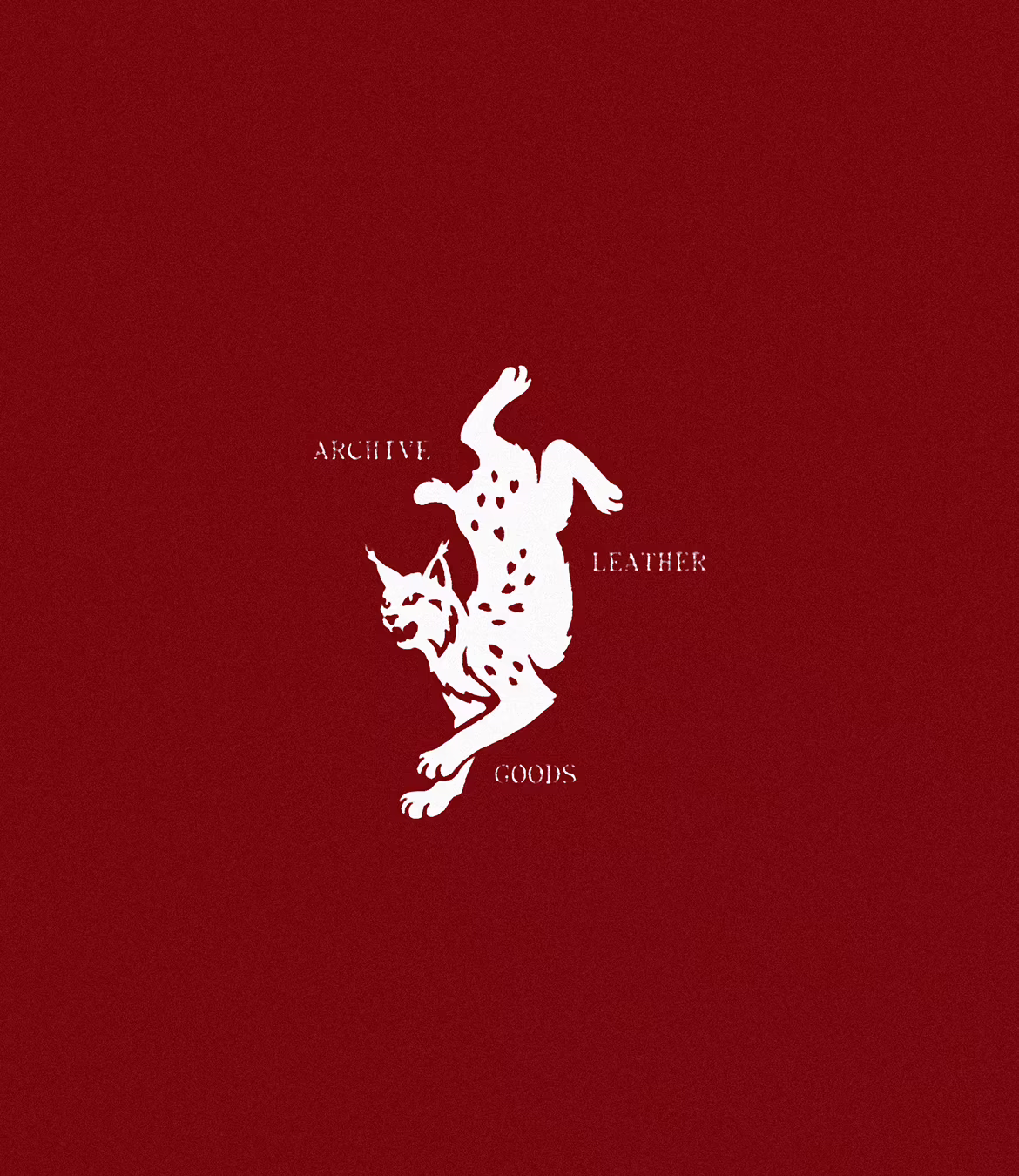 White illustrated wildcat with spots and a fierce expression in a dynamic upside-down pose on a dark red background, with the words 'ARCHIVE,' 'LEATHER,' and 'GOODS' arranged around the cat.