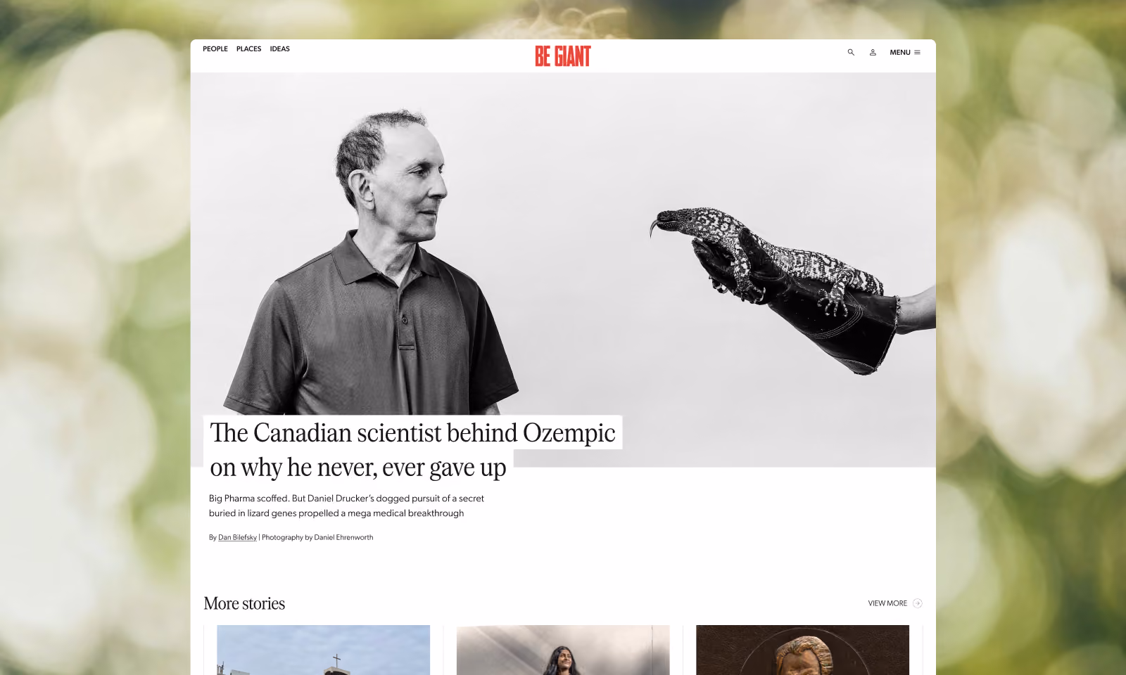 Black and white photo of a man in a polo shirt looking at a lizard perched on a gloved hand extended towards him, featured in an article titled 'The Canadian scientist behind Ozempic on why he never, ever gave up' on the Be Giant website.