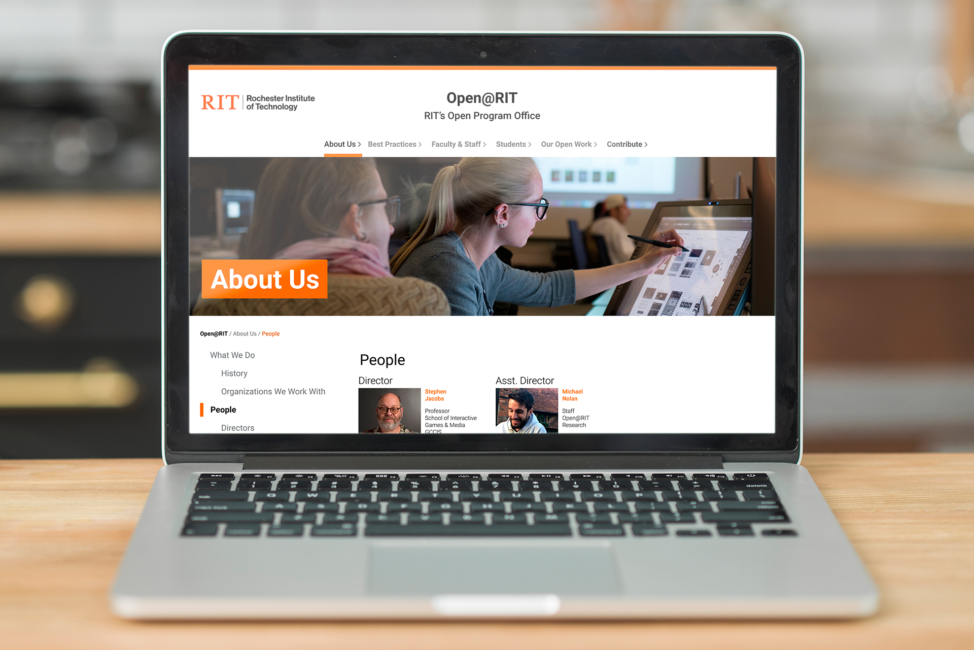 Mockup of a macbook pro, showing on screen the new Open@RIT website design. 