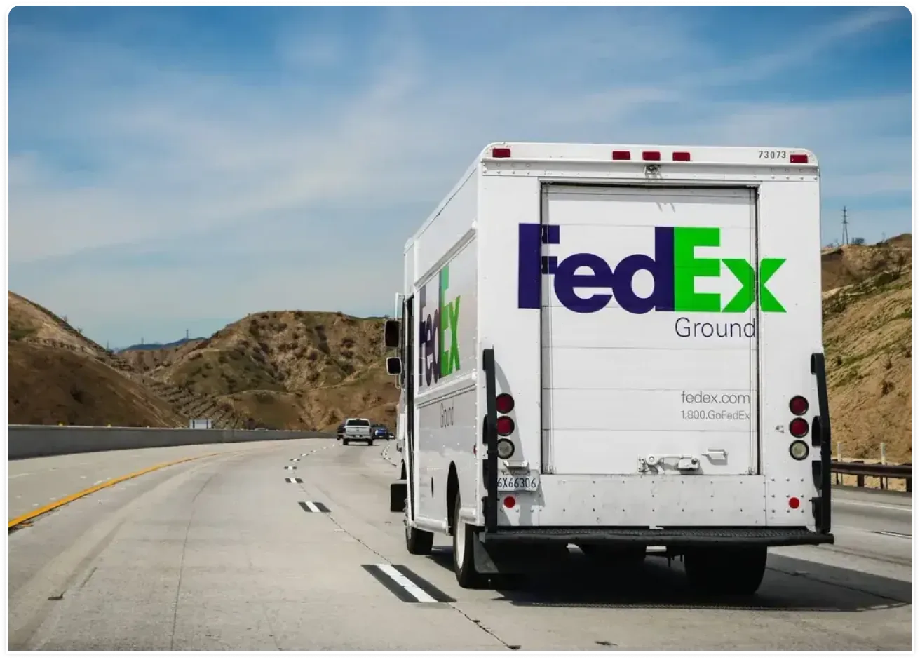 A FedEx Ground truck on the road.