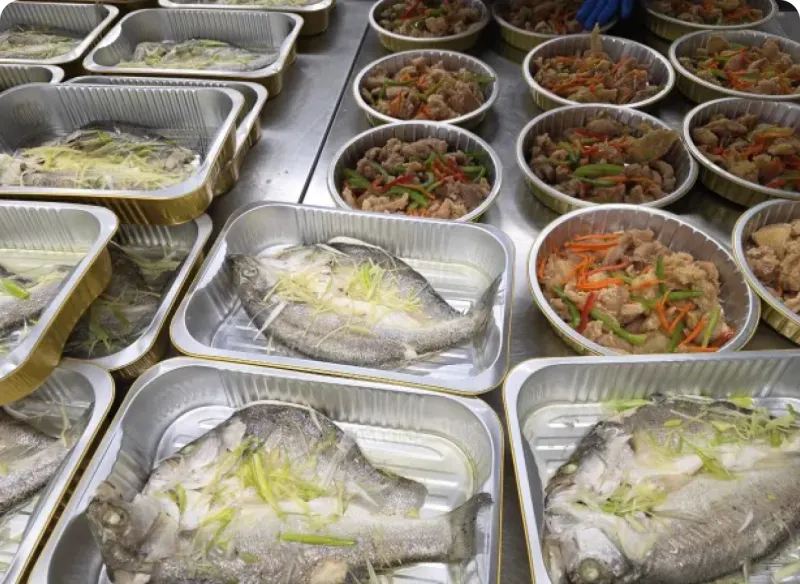 Trays of steamed fish and stir-fried chicken from Three Aunties, ready for delivery