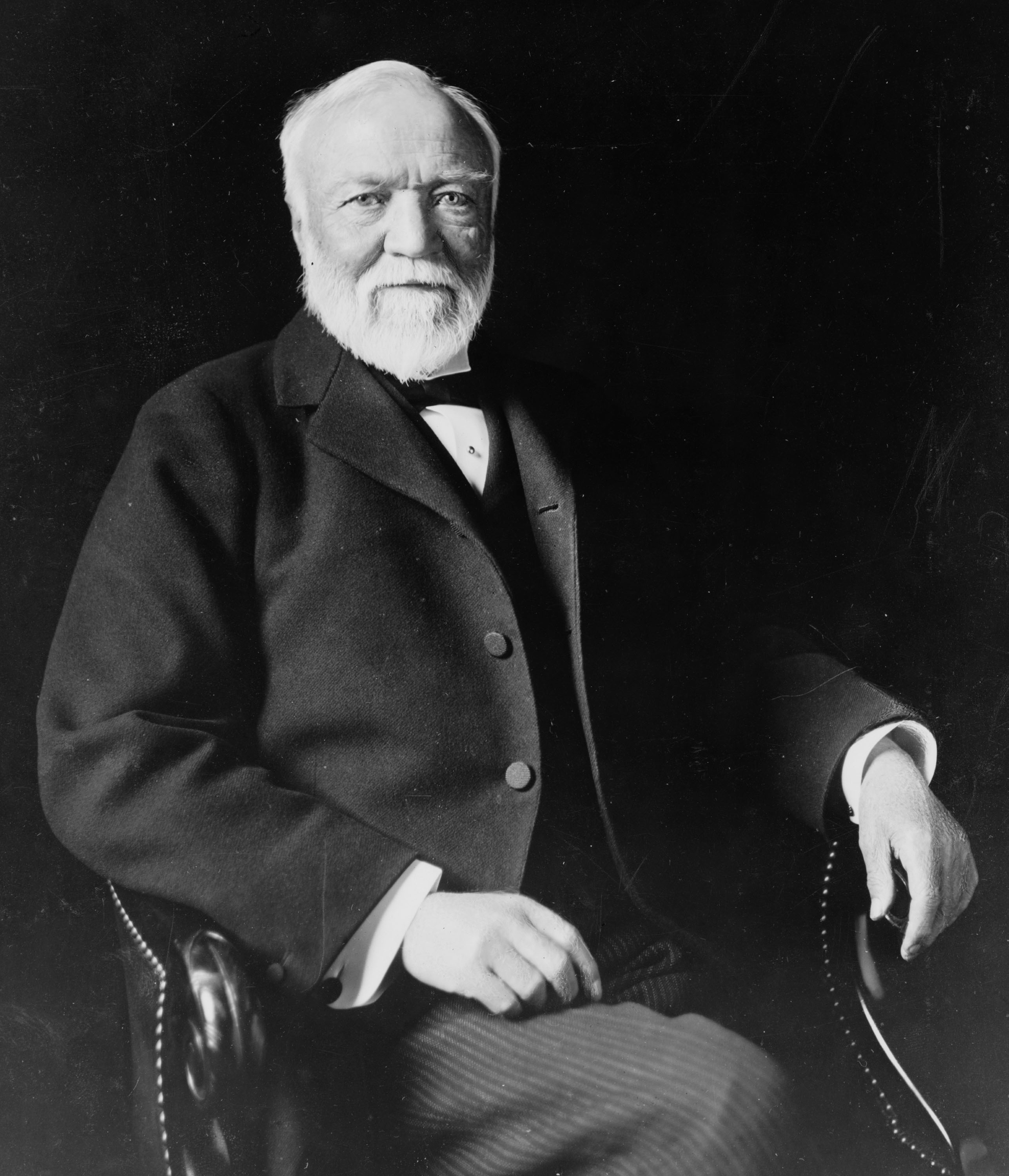 Andrew_Carnegie_three-quarter_length_portrait_seated_facing_slightly_left_1913.jpg