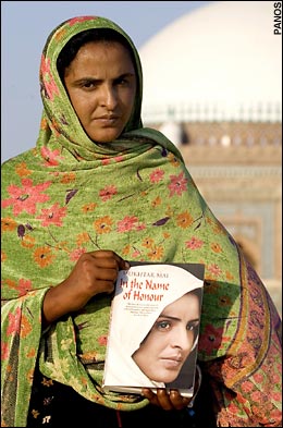 Muktar Mai, holding a copy of her 2007 book. 