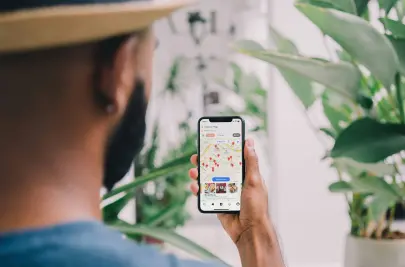 A man is looking at his smartphone navigation app with a multi-stop route