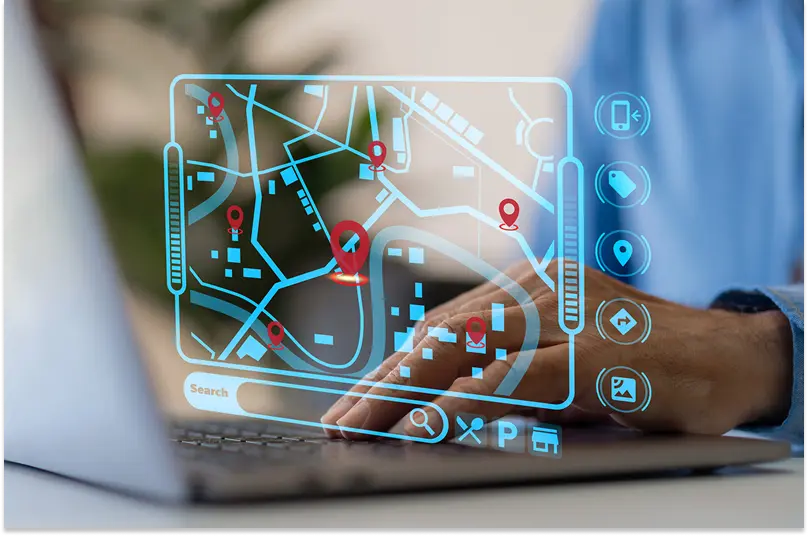 A graphic showing complex routes around a city is overlaid on a photograph of someone’s hands at a laptop keyboard.