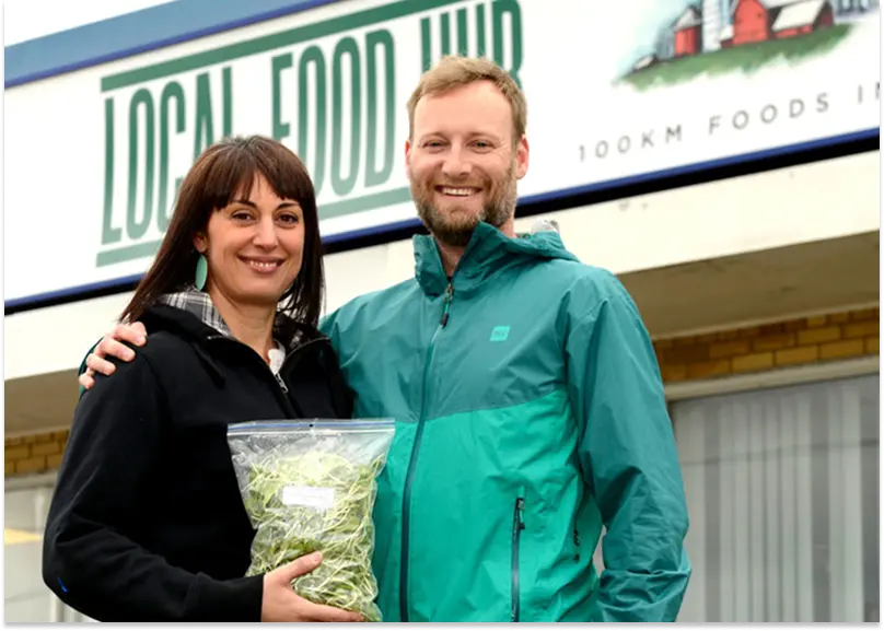 Paul Sawtell and Grace Mandarano pictured in front of their Local Food Hub distribution center.