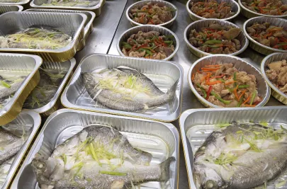 Fresh meals featuring fish and vegetables being prepared for delivery in the Three Aunties kitchen