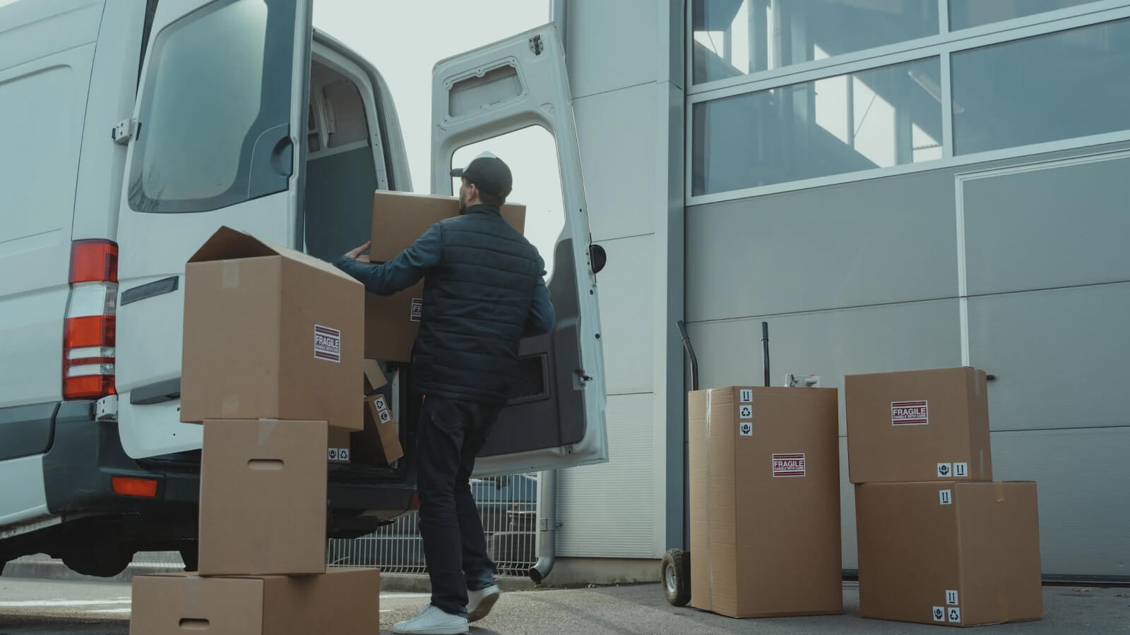 delivery driver loads delivery van