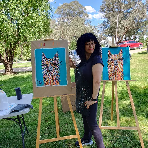 people painting under a marquee