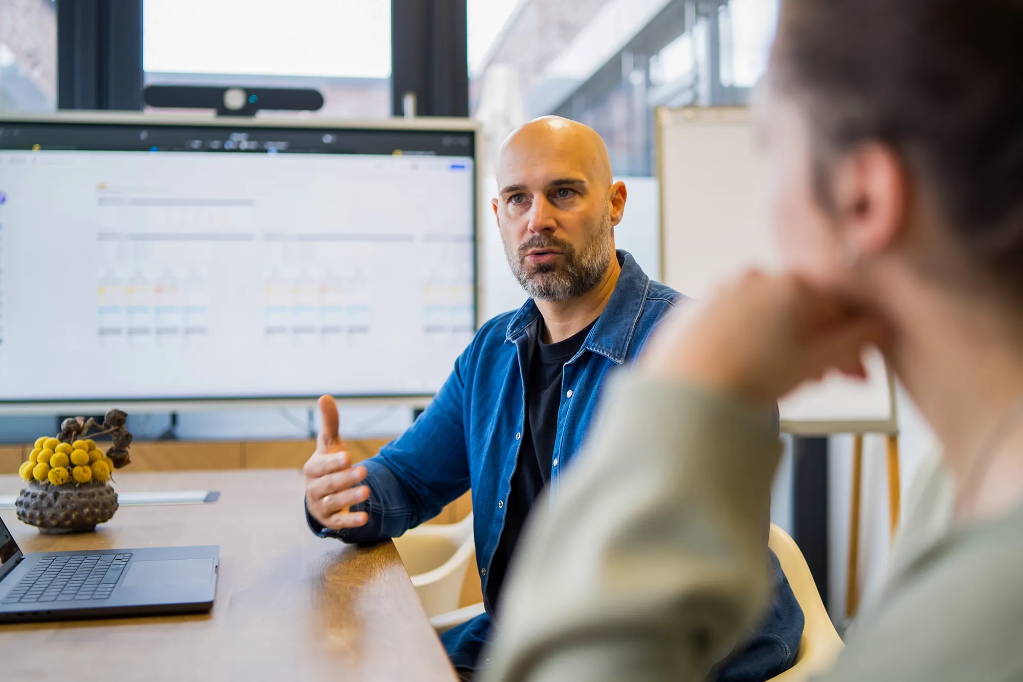 Mitarbeiter zeigt seinen Kollegen Contentful Enterprise Observability.