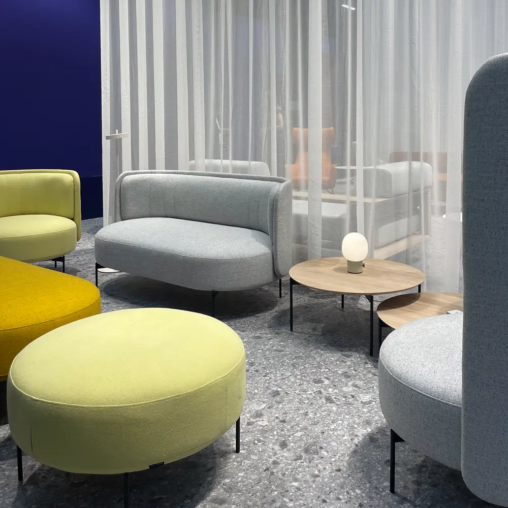 Modern seating furniture by Softline at Orgatec – colorful upholstered pieces and minimalist tables in an elegantly designed setting.