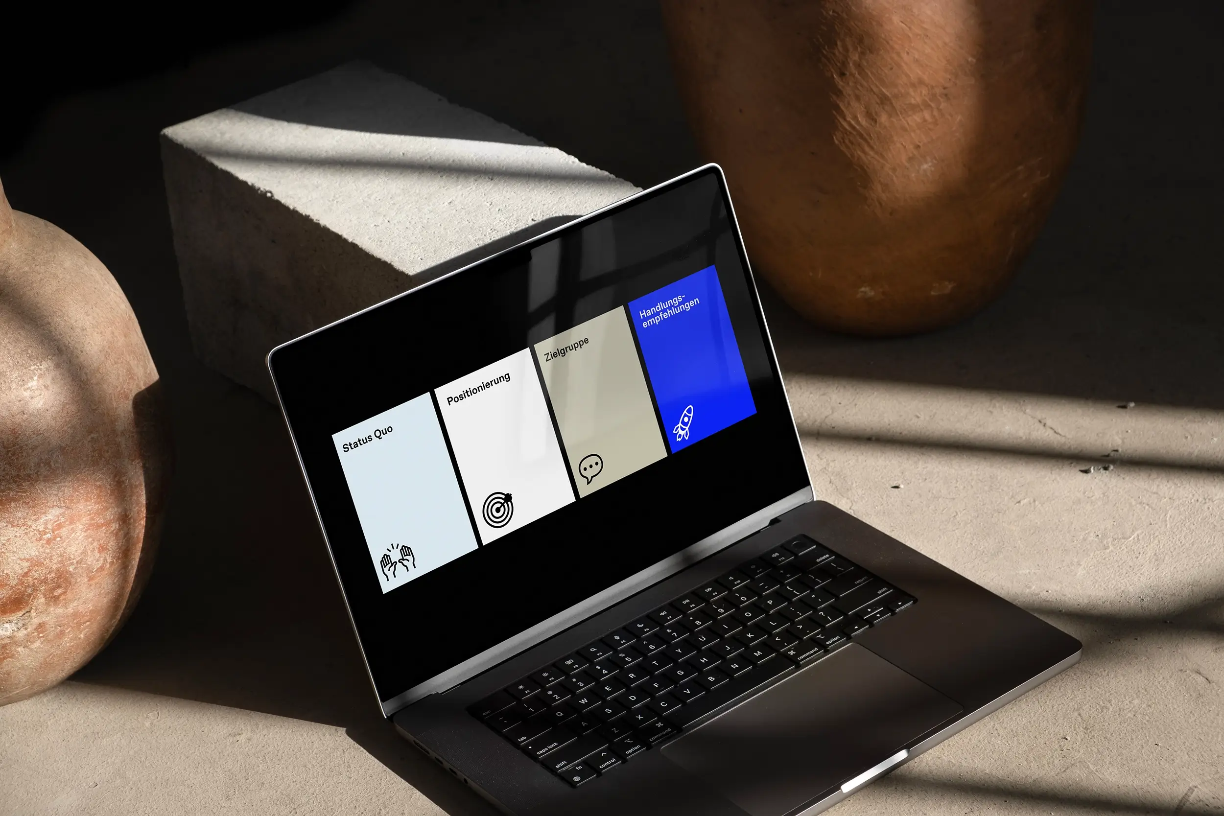 Laptop with open presentation on architecture marketing: slides show the topics status quo, positioning, target group, and recommendations for action.
