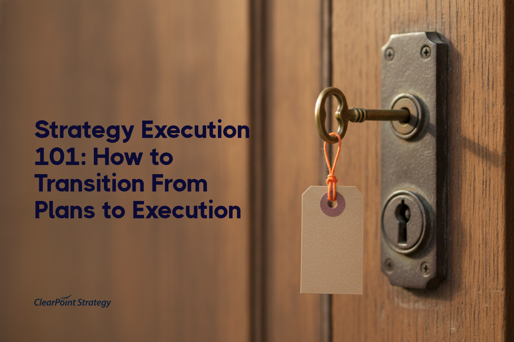 A brass skeleton key with an orange-tied tag inserted into an antique lock on a wooden door, symbolizing ownership and accountability in strategy execution