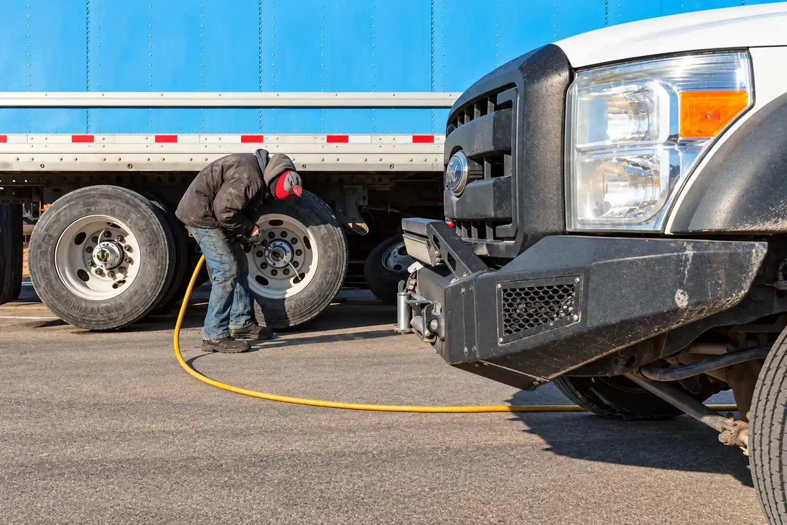 Mechanic performing roadside repairs from Patriot Diesel and Automotive